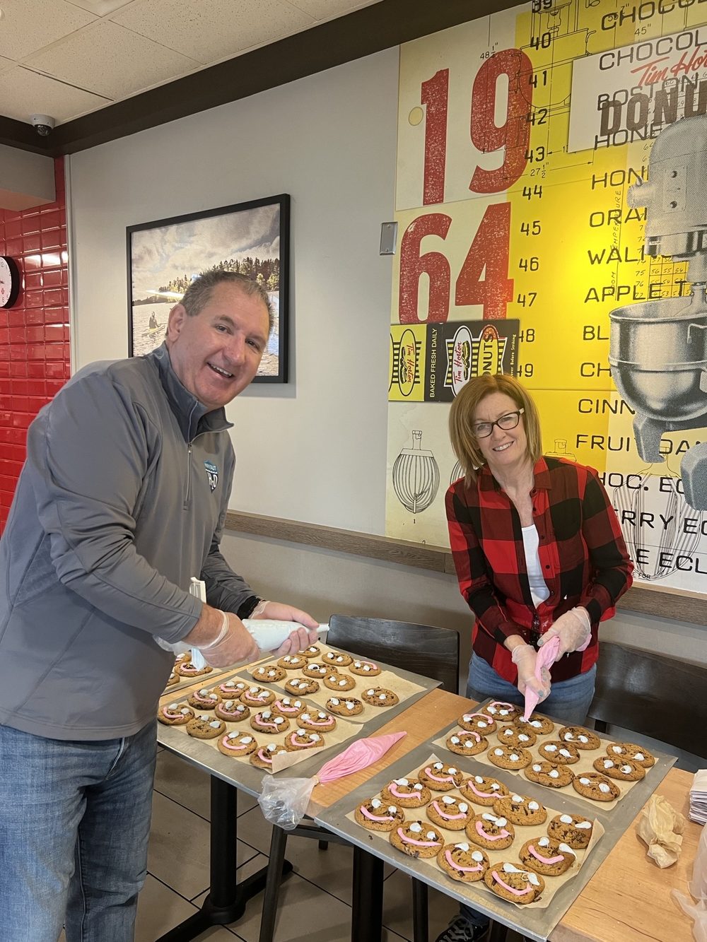 Bill Steele and Debby decorating cookies at a community fundraiser